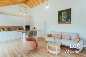 a living room with a couch and a table at Alojamentos Plansel - No Coração das Vinhas do Alentejo in Montemor-o-Novo
