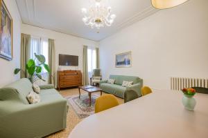 a living room with a table and a couch at Santo Stefano Palace in Venice