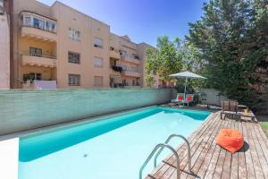 a swimming pool in front of a building at Apartment Barcelona Rentals - Swimming Pool with Terrace in Barcelona
