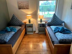 a living room with two beds and a window at Usedomer Landhaus in Kamminke
