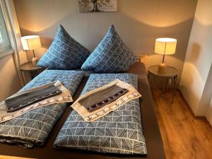 a room with two beds with pillows and two lamps at Usedomer Landhaus in Kamminke