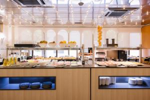 a buffet line with plates of food in a restaurant at Civis Jaime I in Castellón de la Plana
