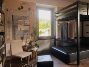 a room with a bunk bed and a table and chairs at cascina lago in Montorfano +6 photos