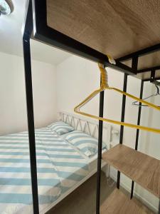 a bedroom with a bunk bed with blue and white stripes at Residence Zar 9 in Trieste