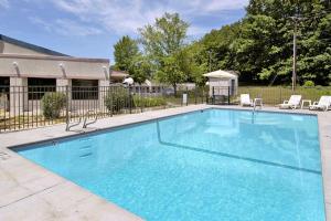 a large blue swimming pool with chairs and a gazebo at Shayona Inn - Eden in Eden