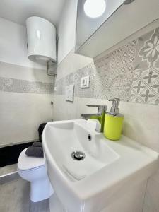 a bathroom with a white sink and a toilet at Residence Zar 9 in Trieste