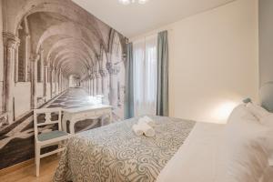 a bedroom with a bed with a teddy bear on it at Santo Stefano Palace in Venice