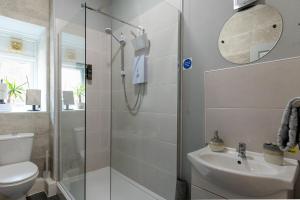 a bathroom with a shower and a toilet and a sink at ORME RISE - Beautiful first floor apartment in Llandudno +13 photos