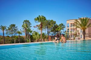 two people in the swimming pool at a resort at PortoBay Blue Ocean in Albufeira