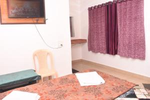 a room with a table and a chair and a window at The Grand Bagicha Residency Matheran in Matheran