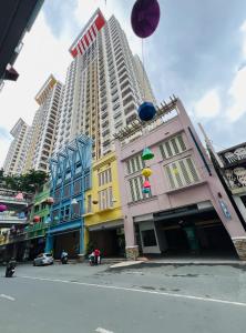 a group of buildings on a street with tall buildings at Casa Tagpuan in Manhattan ParkWay in Manila