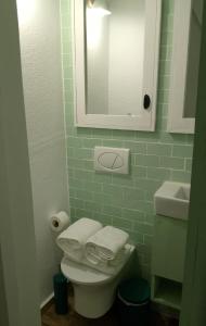 a bathroom with a toilet and a sink and a mirror at Prieto Picudo - Harbor's Light in Villajoyosa