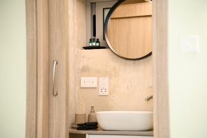 a bathroom with a sink and a mirror on the wall at Ελιά Πόλις - Elia Polis in Polis Chrysochous +18 photos