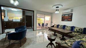 a living room with a couch and a table at Duplex imiouaddar in Agadir nʼ Aït Sa