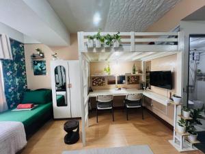 a small room with a bunk bed and a desk at Casa Tagpuan in Manhattan ParkWay in Manila