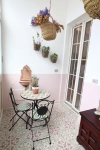 a room with a table and two chairs and a table at At Home - Luxury apartment Bari in Bari