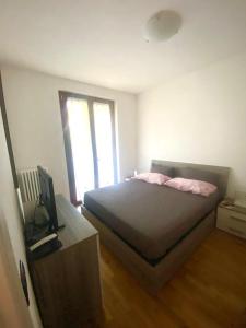 a bedroom with a bed and a television in it at Wendy House RESIDENCE CORTE COLLINA in Castion Veronese +10 photos