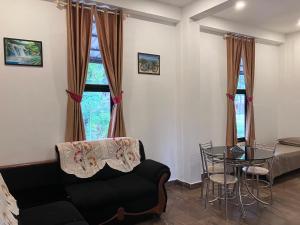 a living room with a couch and a table at Thushara Homestay in Paithalmala