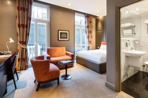a hotel room with a bed and a bathroom at Radisson Blu Hotel, London Marble Arch in London