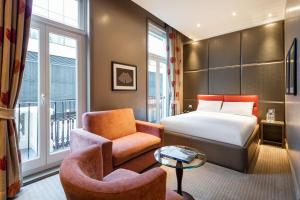 a hotel room with a bed and a chair at Radisson Blu Hotel, London Marble Arch in London