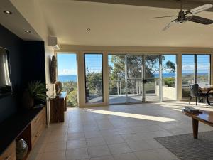 a living room with a view of the ocean at Pikes Point Beach House in Merimbula