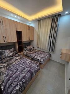 a room with two beds and a window in it at Porto matrouh Blue sea in Marsa Matruh