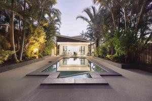 a house with a swimming pool in the middle of a yard at Golden Beach Oasis - Sleeps 12 in Golden Beach