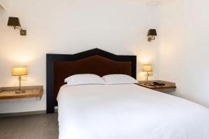 Postel nebo postele na pokoji v ubytování Hotel Kabila