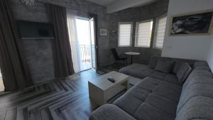 a living room with a couch and a table at Captain's View in Dobra Voda