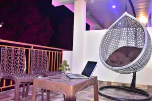a hammock with a laptop on a table and a bed at Inder Homestay Kasuali in Kasauli