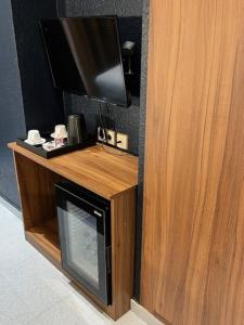 a flat screen tv on top of a wooden entertainment center at Hotel Aneto in Barcelona