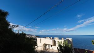 a view of the ocean and a building at Captain's View in Dobra Voda