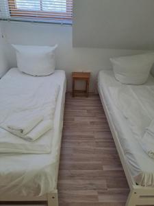 two beds sitting next to each other in a room at Schwalbenweg in Zingst