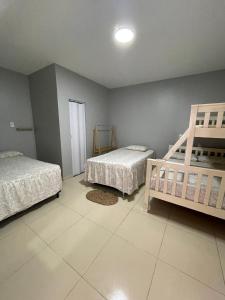 a bedroom with two beds and a ladder in it at Nosso Quintal in Santo Amaro +17 photos