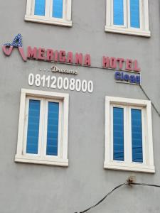 a hotel sign on the side of a building at Americana Hotel in Suru Lere +25 photos