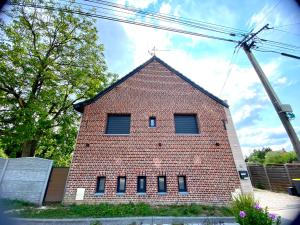 a brick building with windows on the side of it at Capsule la grange arcade de jeux billard 4 chambres 300m2 in Vicq