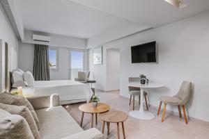 a hotel room with a bed and a couch at Almyra Resort in Koutsounari