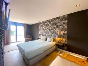 a bedroom with a large bed and a large window at Capsule la grange arcade de jeux billard 4 chambres 300m2 in Vicq