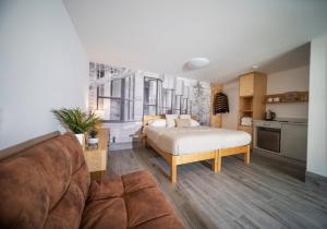 a living room with a bed and a couch at Lodges at Flimwell Park in Ticehurst