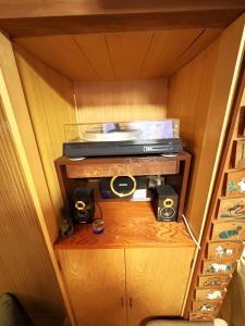 a small room with a tv and speakers on a shelf at Nikko-Imaichi "The LINKs" Dormitory House in Nikko +30 photos