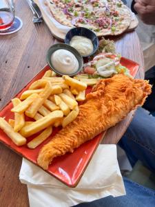a plate of food with fish and french fries at Veenland Hotel in Haren