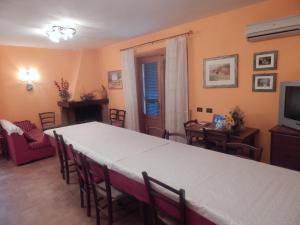 a dining room with a table and chairs and a television at Piane Del Bagno in Saturnia