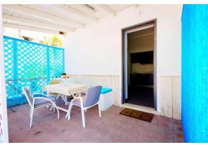 Un patio con una mesa y sillas en un balcón. en Il Sogno, en Milazzo