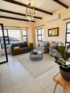a living room with a couch and a table at The Exec Home Self Catering Villa in Gaborone