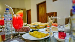 a table with plates of food and a drink at Temple Entrance Villa in Dambulla +48 photos