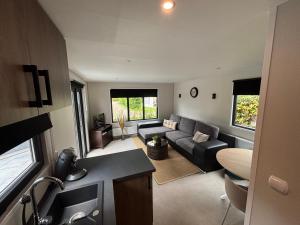 a living room with a couch and a living room with at Eiberts nest in Nunspeet