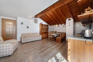 a kitchen and living room with a refrigerator and a table at Casa Vendrogno in Bellano