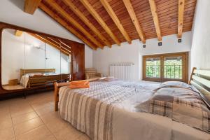 a bedroom with a large bed and a mirror at Casa Vendrogno in Bellano