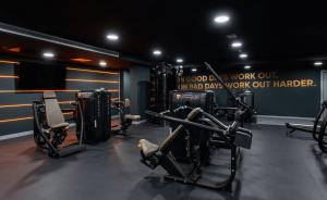 a gym with several treadmills and machines in a room at Stylish Studio in Citysuites in Manchester