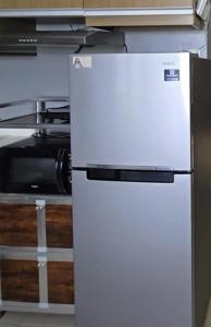 a white refrigerator in a kitchen next to a microwave at Studio With Citylights and SEAview near MALL inside IT PARK in Sampong